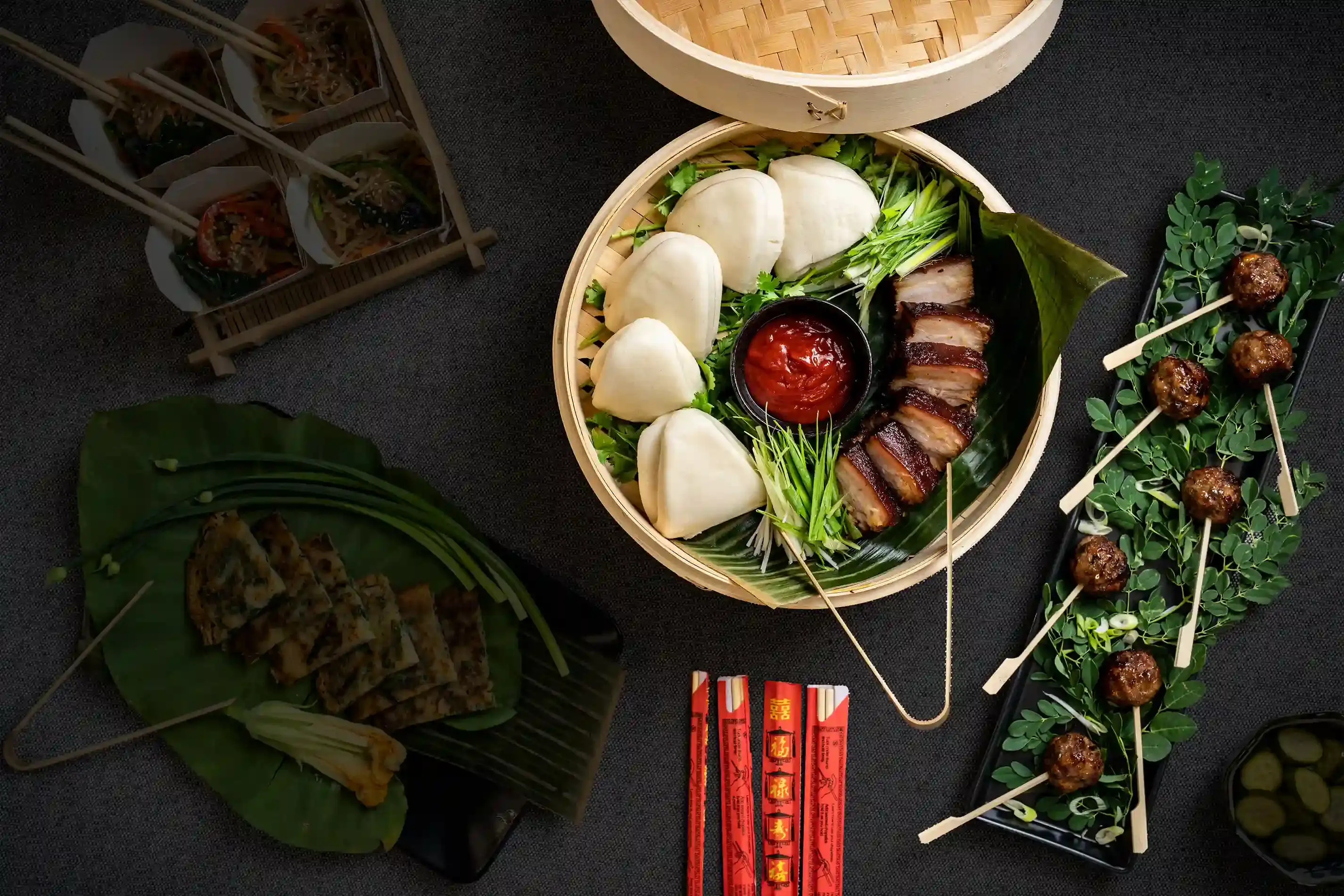 A picture of a table set with delicious asian-fusion food from K Catering