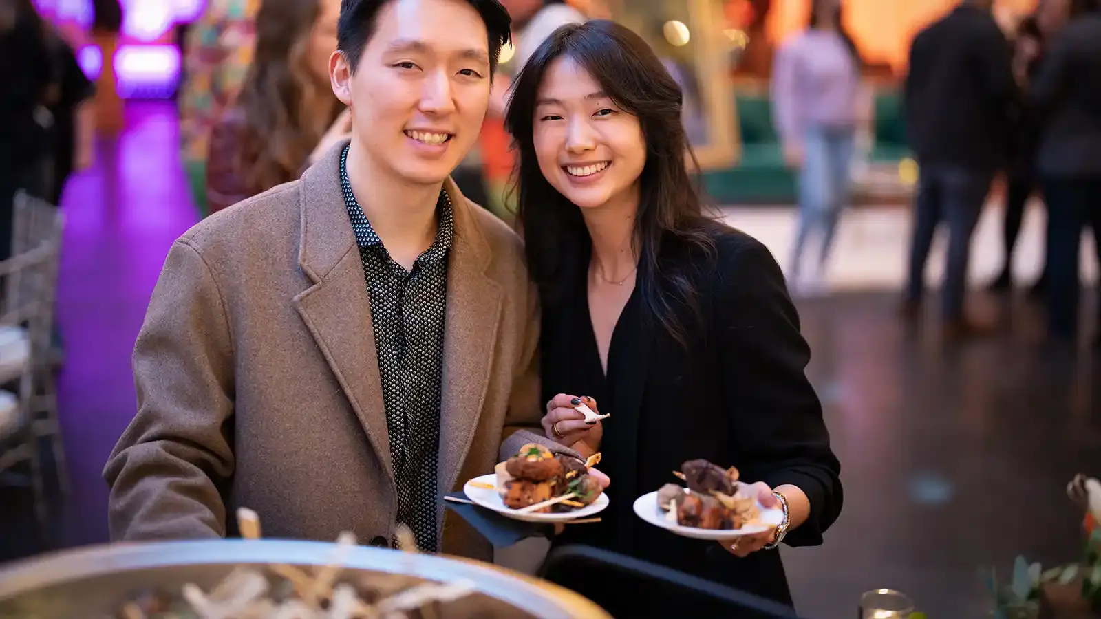 A happy couple eating at a K Catering event.
