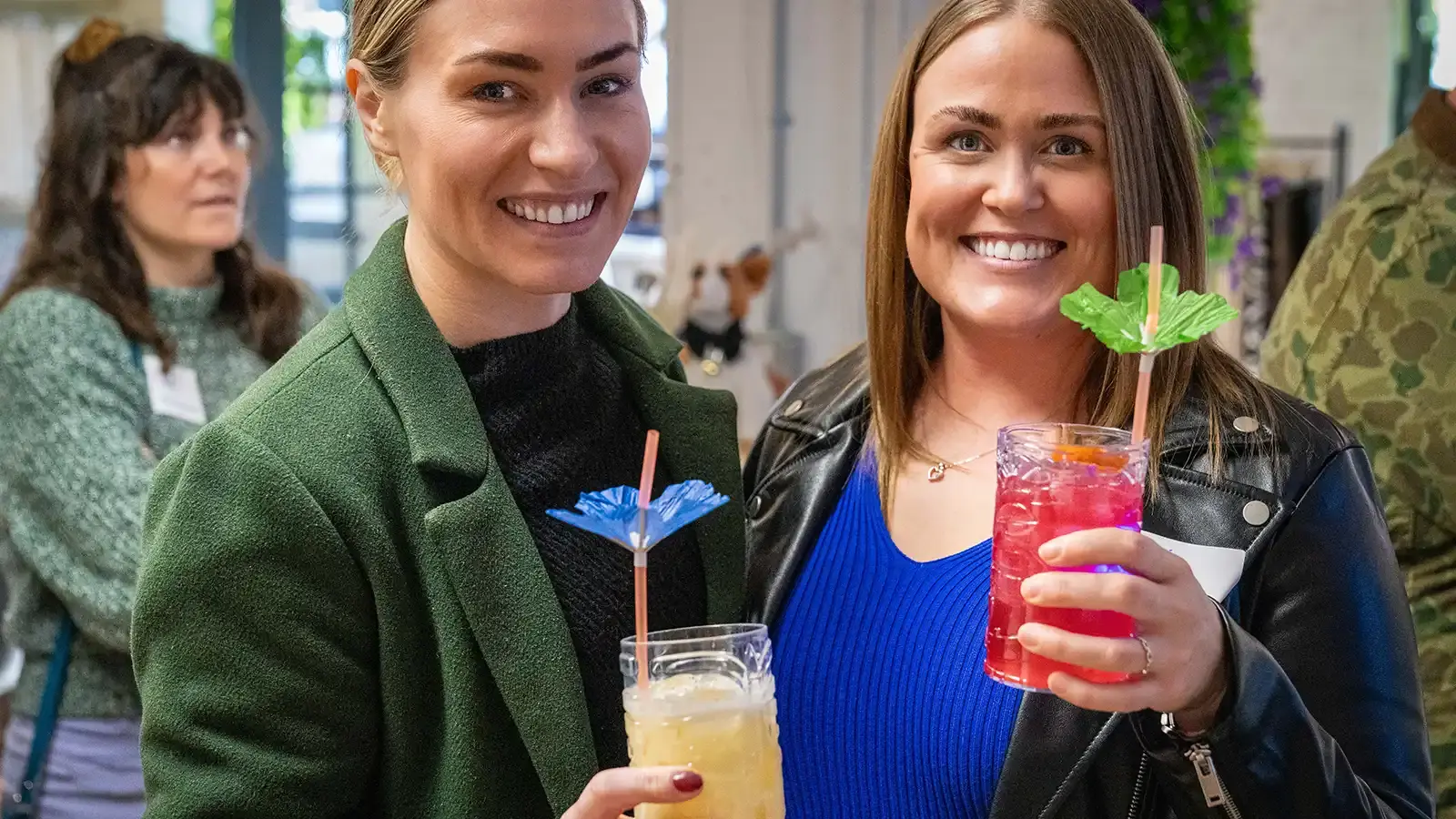 Two guests enjoying tropical drinks with umbrellas