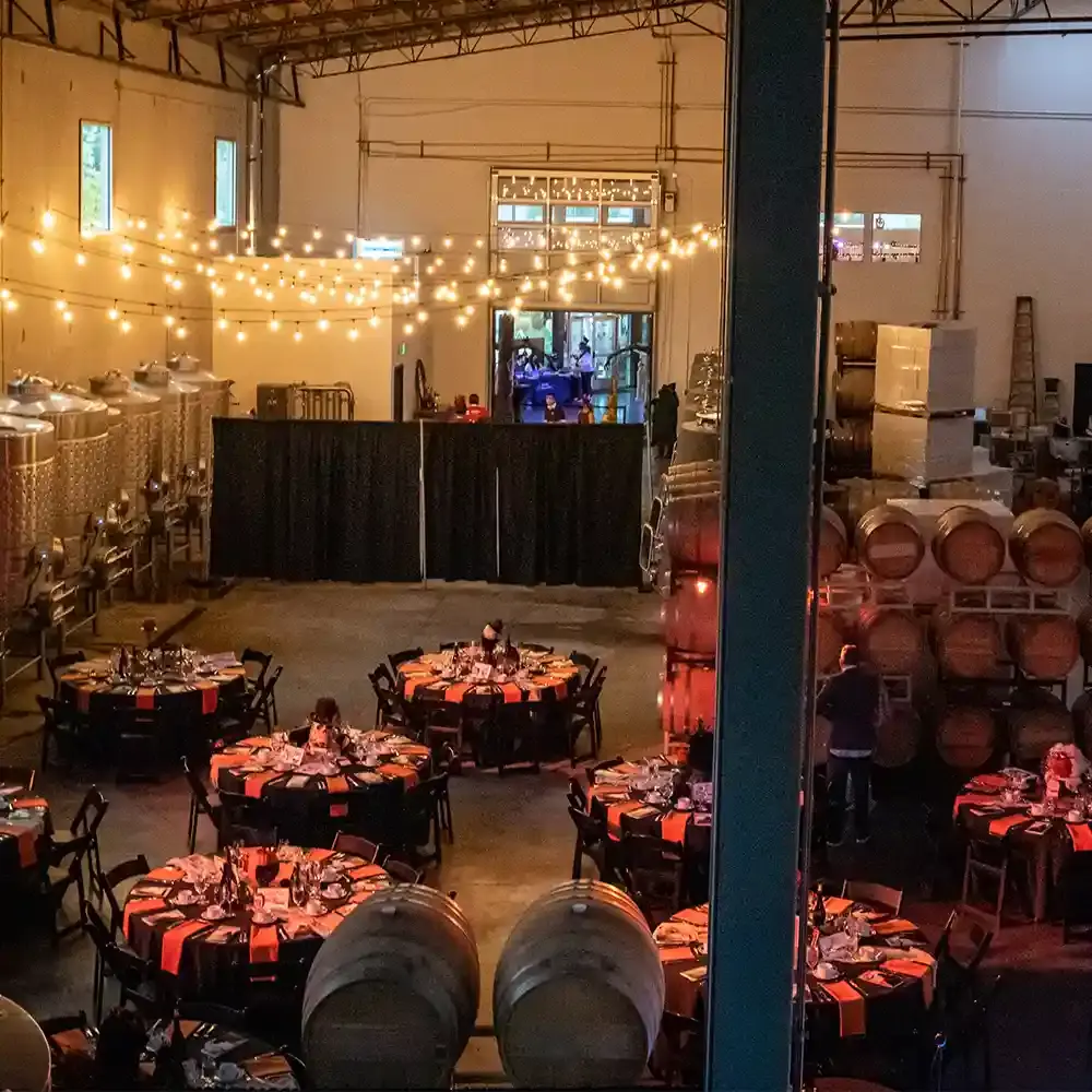 A large event space with tables set ready to be served